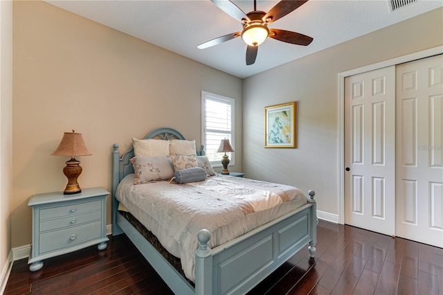 bedroom with ceiling fan, dark wood-type flooring, and a closet