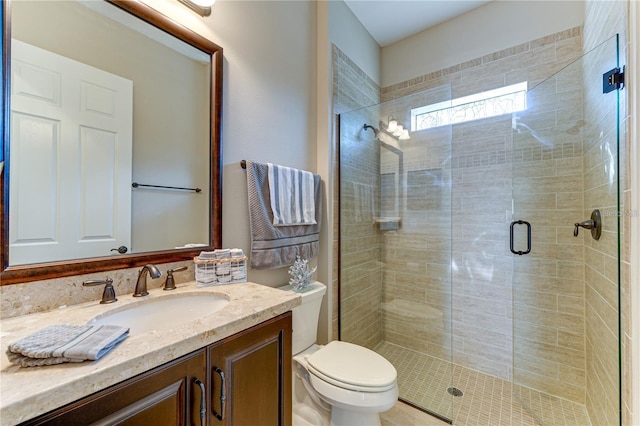 bathroom with vanity, toilet, and an enclosed shower