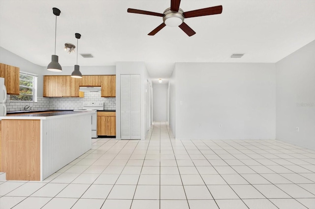 kitchen with ceiling fan, sink, backsplash, decorative light fixtures, and range