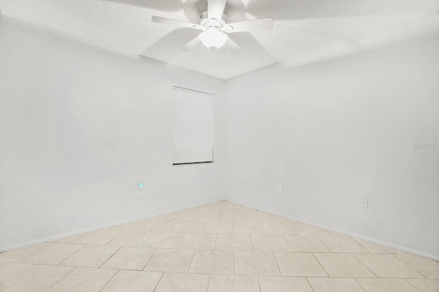 empty room featuring ceiling fan and a textured ceiling