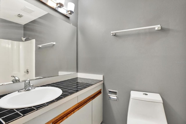 bathroom featuring vanity and toilet