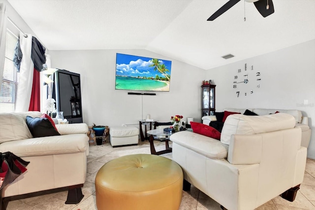 living room with ceiling fan, light tile patterned flooring, and lofted ceiling