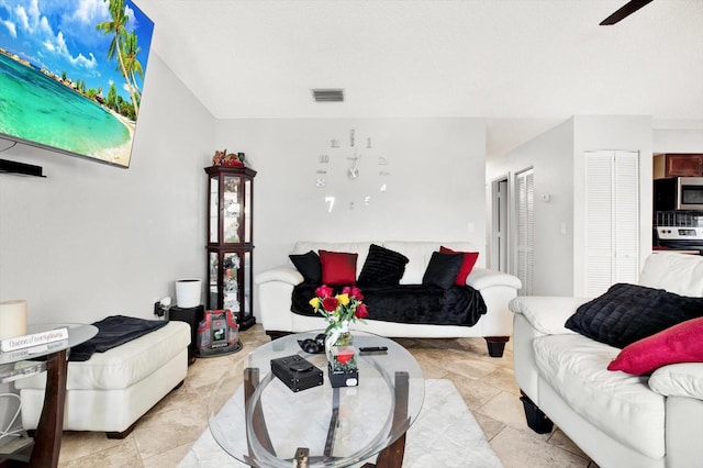 living room featuring ceiling fan and light tile patterned flooring