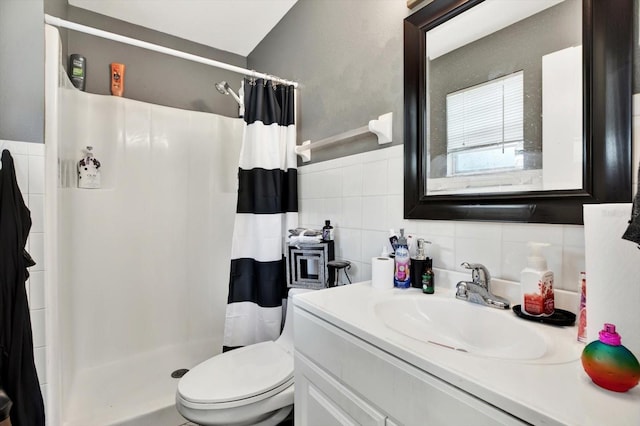 bathroom with vanity, backsplash, toilet, walk in shower, and tile walls