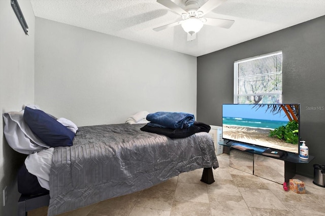 bedroom featuring a textured ceiling and ceiling fan