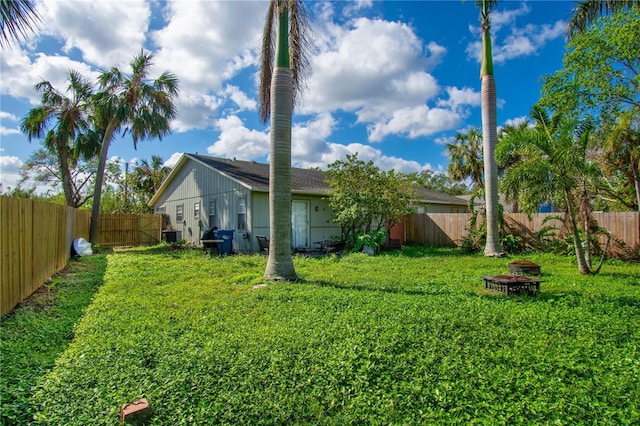 view of yard with a fire pit