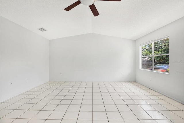 tiled empty room featuring ceiling fan and lofted ceiling