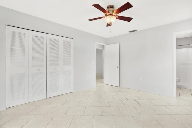 unfurnished bedroom with ensuite bath, ceiling fan, and light tile patterned flooring