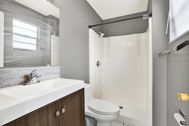 bathroom with a shower, tile patterned flooring, vanity, and toilet