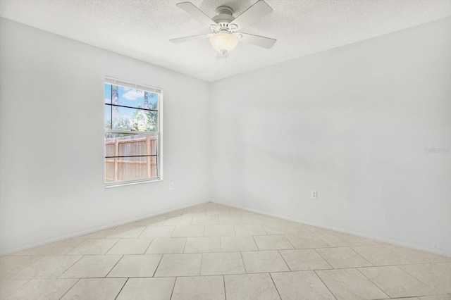 empty room featuring a textured ceiling and ceiling fan