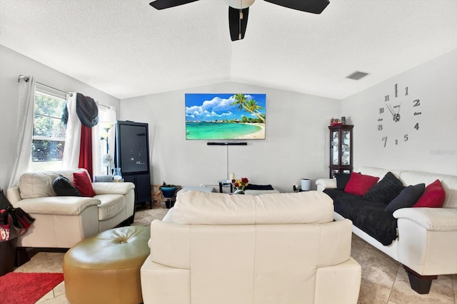 tiled living room with ceiling fan, lofted ceiling, and a textured ceiling