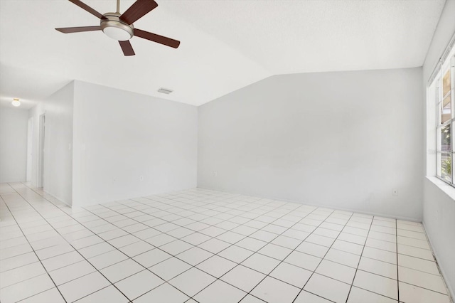 unfurnished room featuring vaulted ceiling, ceiling fan, and light tile patterned flooring