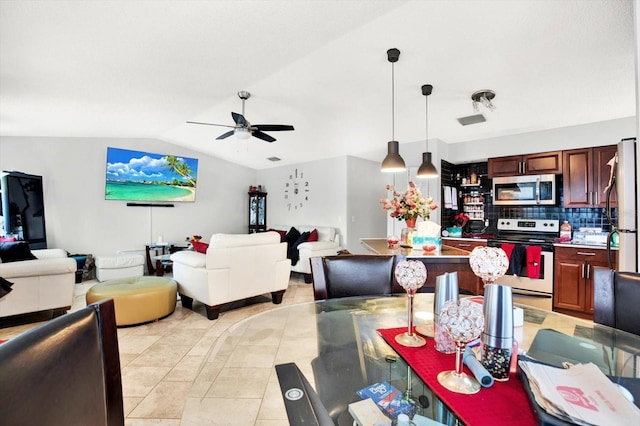 dining space featuring ceiling fan, light tile patterned flooring, and lofted ceiling