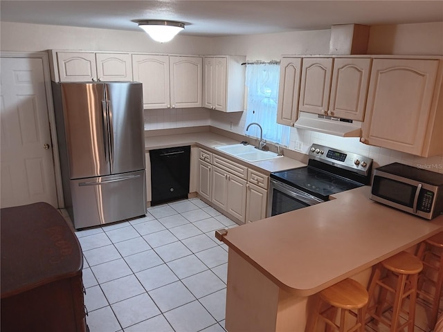 kitchen with sink, decorative backsplash, light tile patterned floors, appliances with stainless steel finishes, and kitchen peninsula