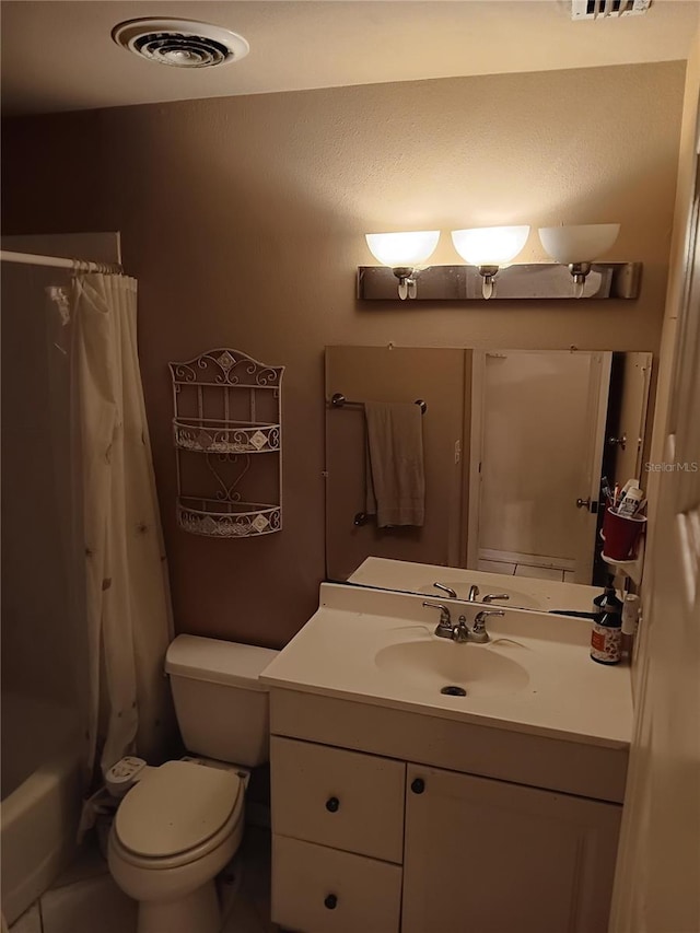 full bathroom with vanity, shower / bath combo, and toilet