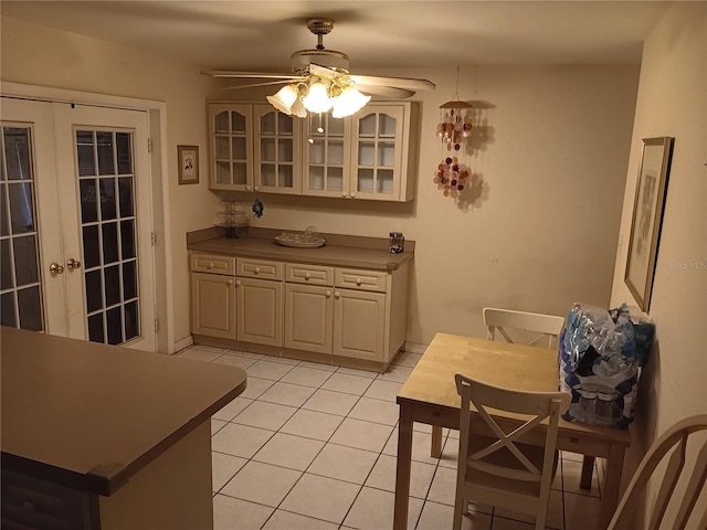 dining room with french doors, light tile patterned floors, and ceiling fan