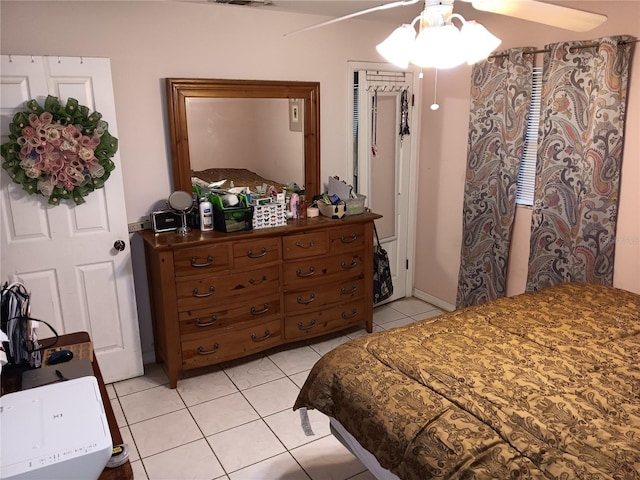 tiled bedroom with ceiling fan