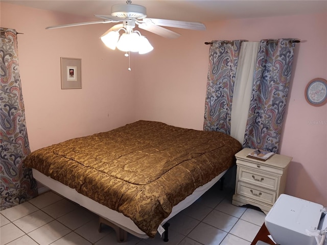 tiled bedroom featuring ceiling fan