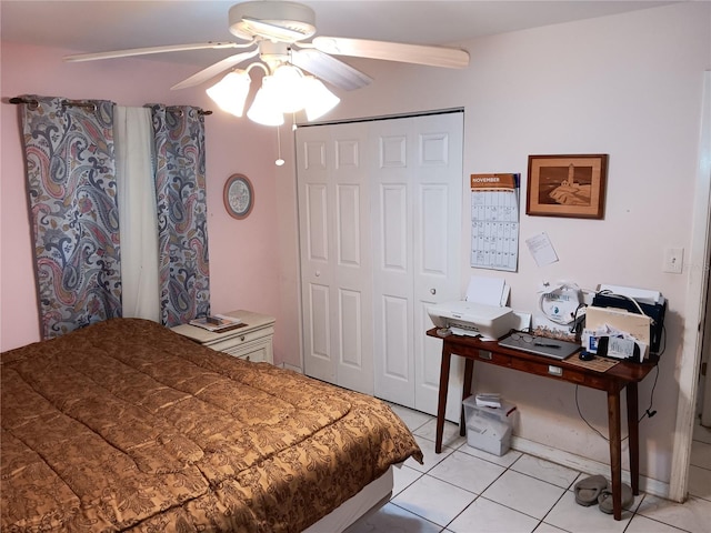 tiled bedroom featuring ceiling fan and a closet