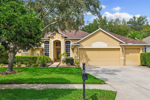 view of front facade featuring a front yard and a garage