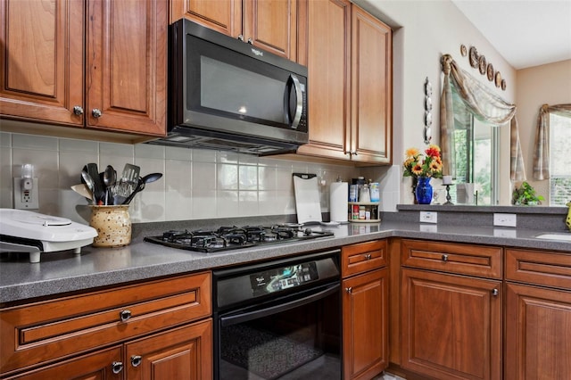 kitchen with backsplash, appliances with stainless steel finishes, and sink