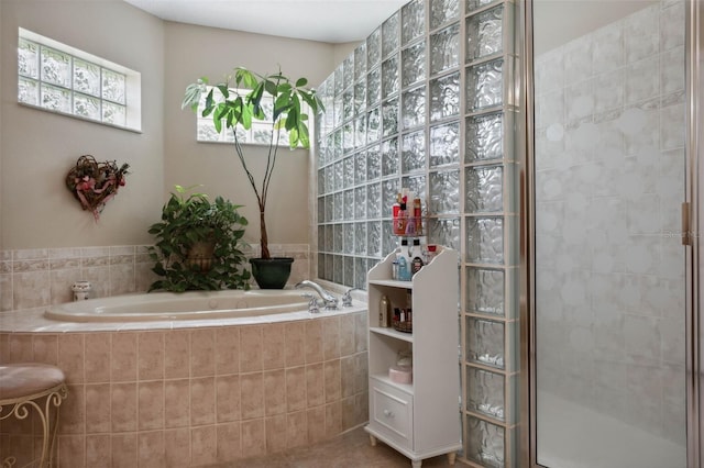 bathroom featuring shower with separate bathtub