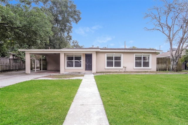 ranch-style home featuring a front lawn and a carport