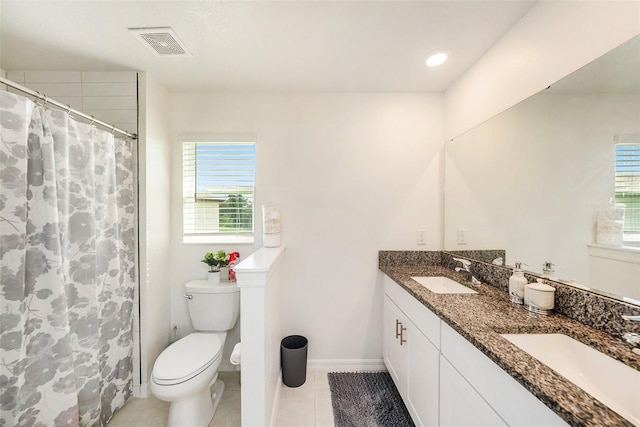 bathroom featuring tile patterned flooring, vanity, and toilet