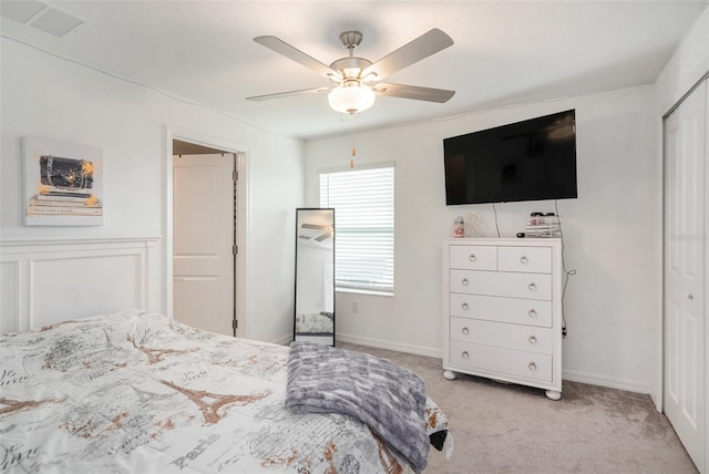 carpeted bedroom featuring ceiling fan and a closet