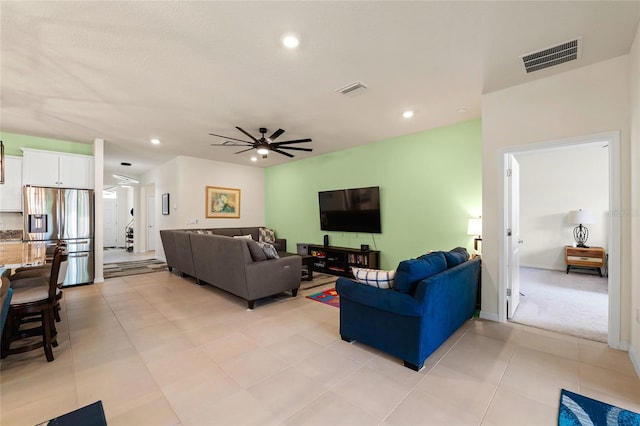 living room with ceiling fan and light tile patterned floors