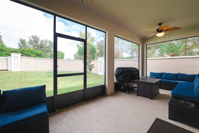 sunroom featuring ceiling fan