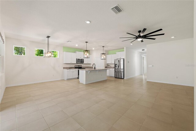 11892 Frost Aster Dr, Riverview, FL 33579 - kitchen with open floor plan, appliances with stainless steel finishes, recessed lighting, a kitchen island with sink, and white cabinetry
