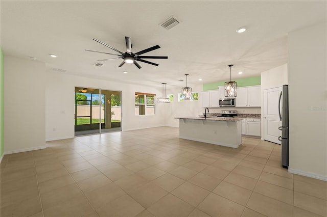11892 Frost Aster Dr, Riverview, FL 33579 - kitchen featuring stainless steel appliances, open floor plan, recessed lighting, a ceiling fan, and white cabinets