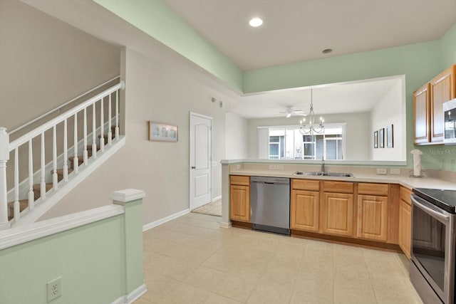 kitchen featuring sink, an inviting chandelier, decorative light fixtures, light tile patterned floors, and appliances with stainless steel finishes