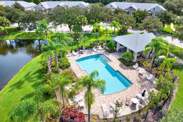 view of pool with a water view and a patio