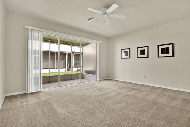 carpeted spare room featuring ceiling fan