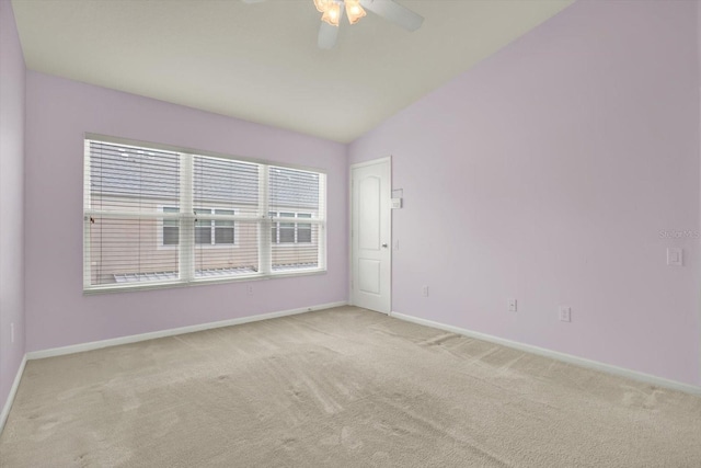 carpeted empty room featuring vaulted ceiling and ceiling fan