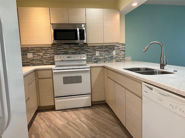 kitchen with decorative backsplash, white appliances, sink, and light brown cabinets