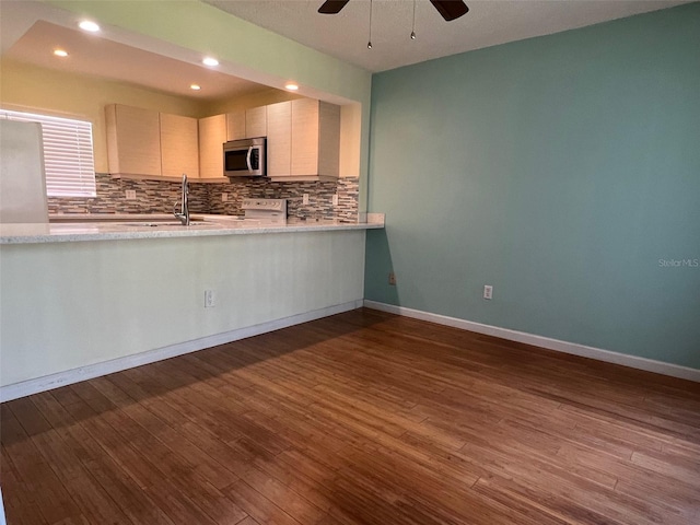 kitchen with ceiling fan, sink, tasteful backsplash, and dark hardwood / wood-style flooring