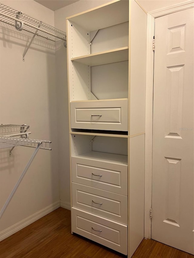 walk in closet featuring dark hardwood / wood-style flooring