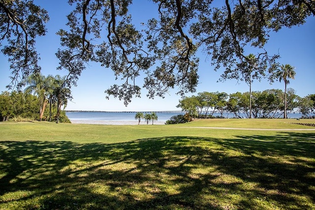 surrounding community featuring a yard and a water view