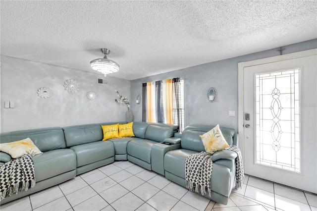 living room with a textured ceiling and a healthy amount of sunlight