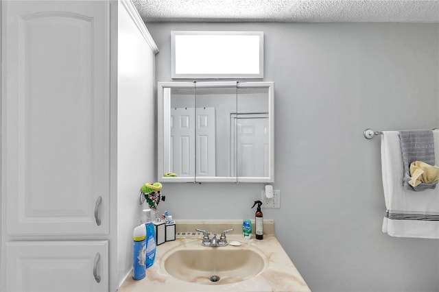 bathroom featuring a textured ceiling and sink