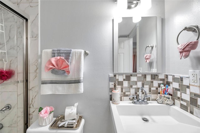 bathroom featuring an enclosed shower, sink, and tasteful backsplash