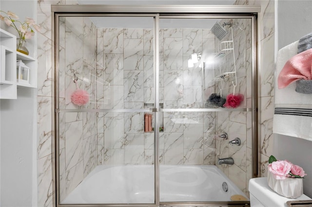 bathroom featuring enclosed tub / shower combo and toilet