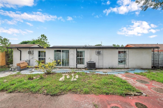 view of front of property with a patio and central AC