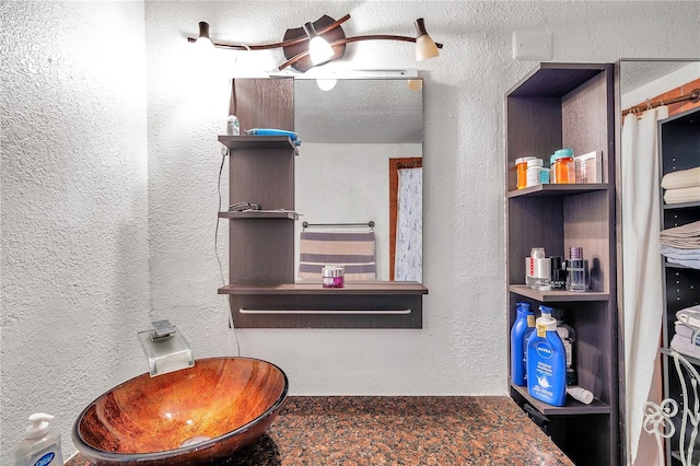 bathroom with a textured ceiling and sink