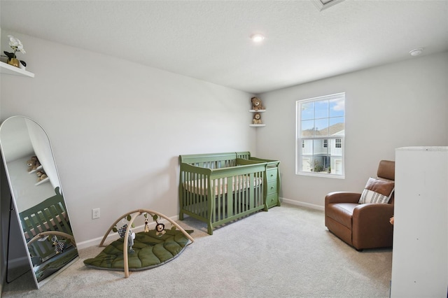 carpeted bedroom with a crib