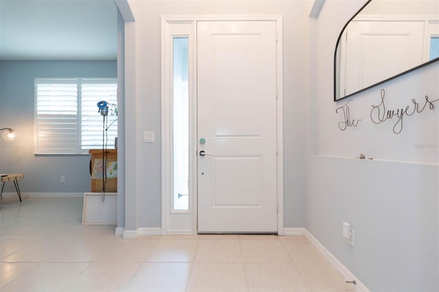 foyer entrance with light tile patterned floors