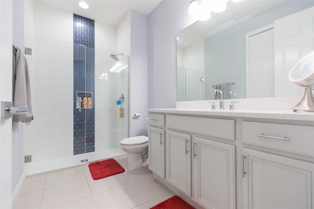 bathroom featuring walk in shower, vanity, tile patterned floors, and toilet